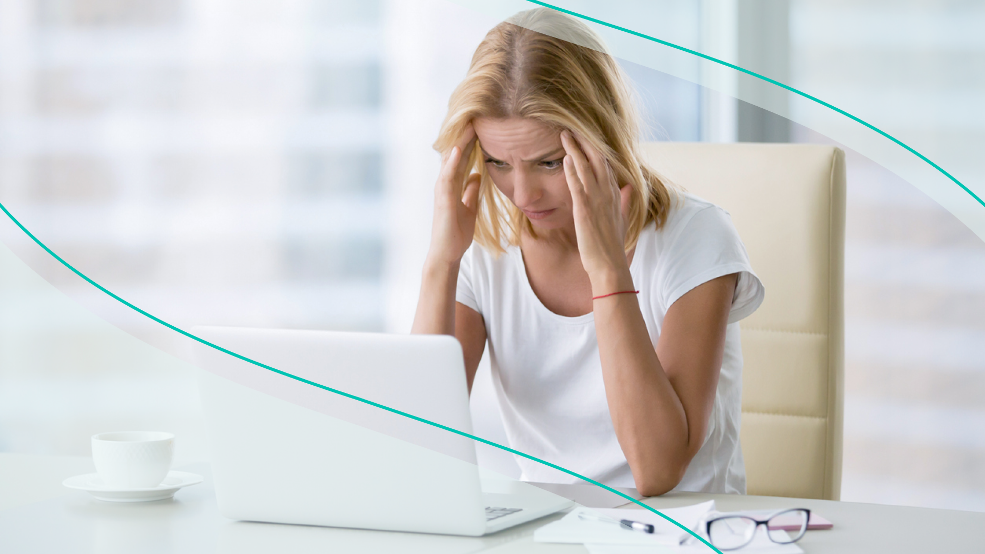 accessibility, woman at desk massaging temples in frustration