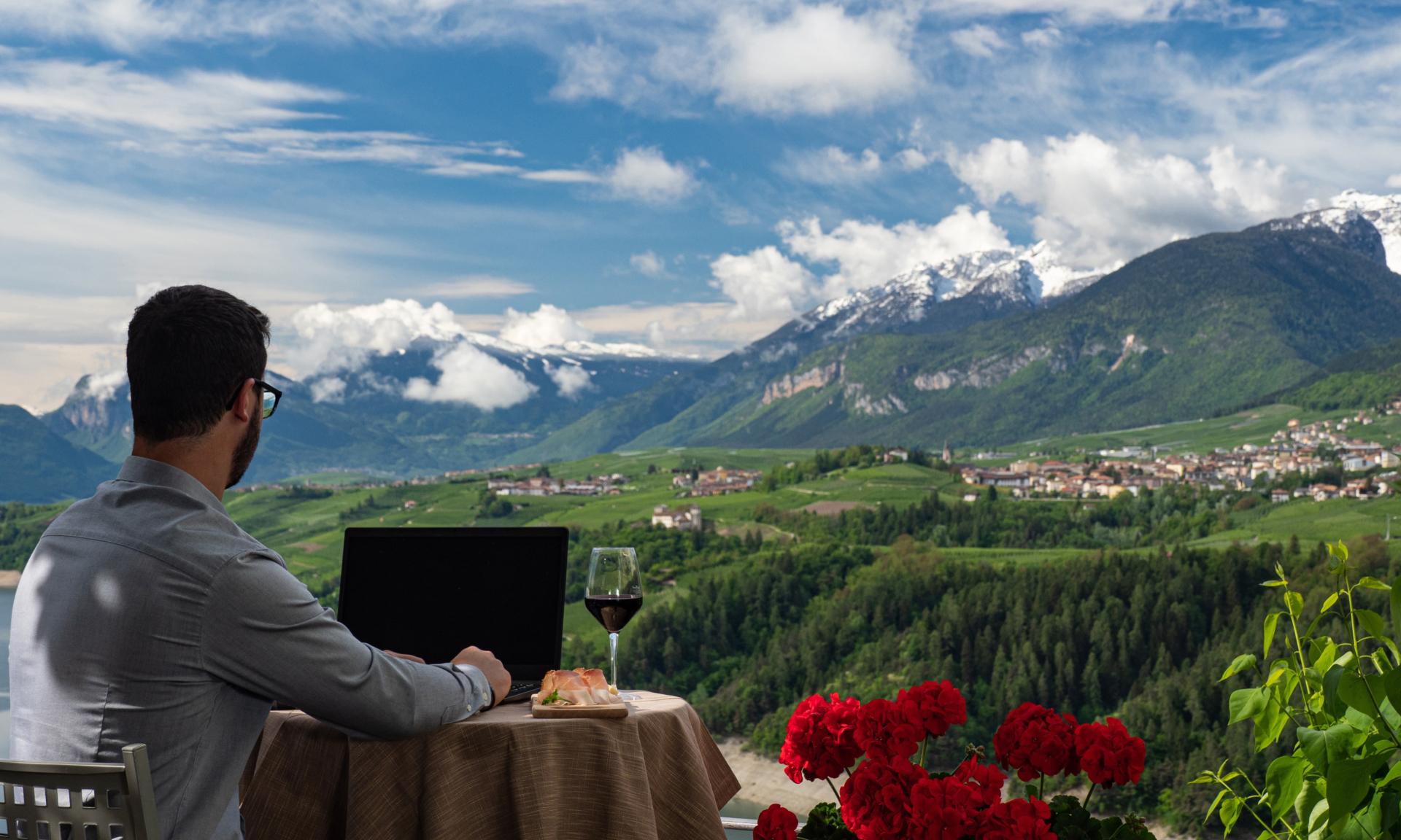 Man remote working in front of a mountain 