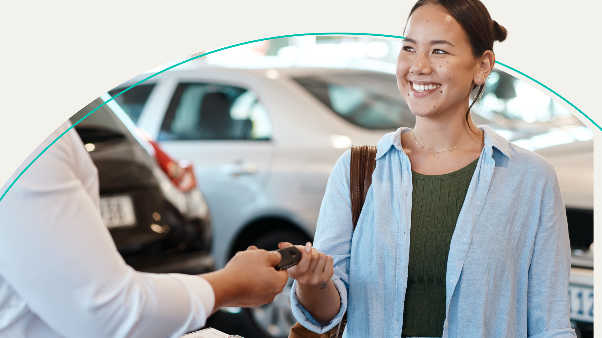 woman getting keys at car lot